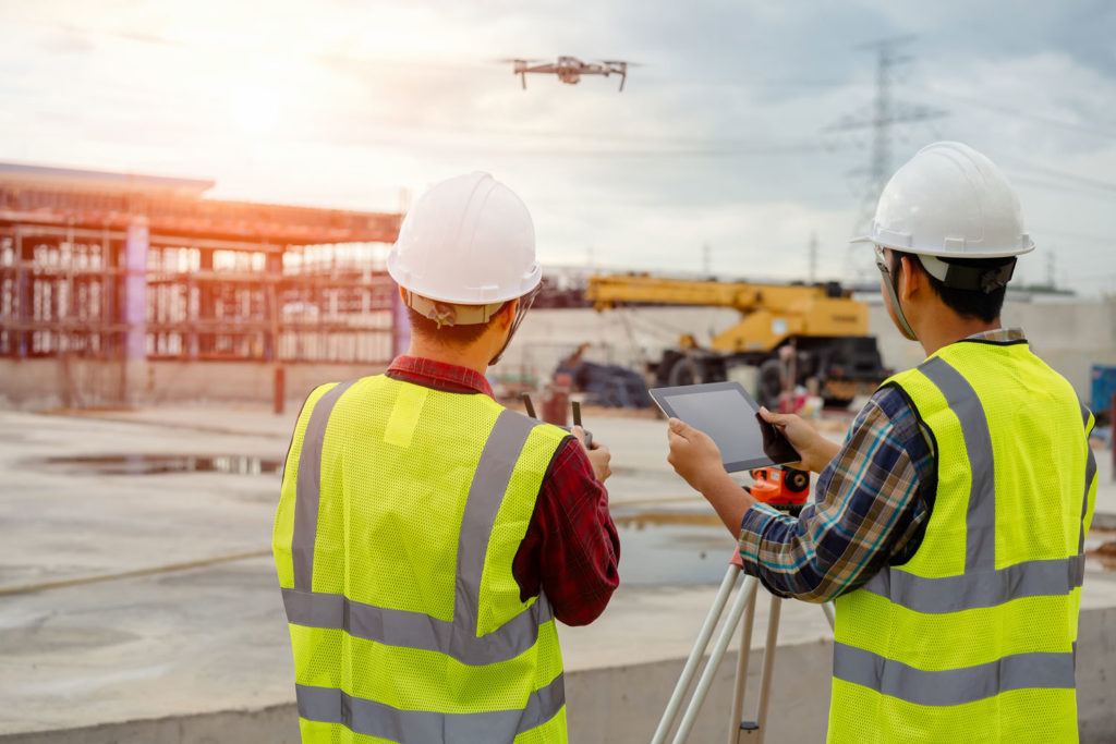Professional drone operator with enterprise survey drone against Arizona blue sky